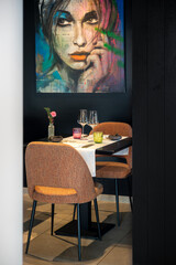 Romantic table with soft ambiance. Elegant dinner scene featuring artwork and dim lighting ambiance © Oksana