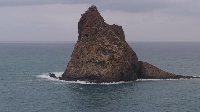 Scenic long exposure capturing the majestic Roques de Anaga sea stacks rising from the Atlantic Ocean near Benijo beach in Tenerife, Canary Islands