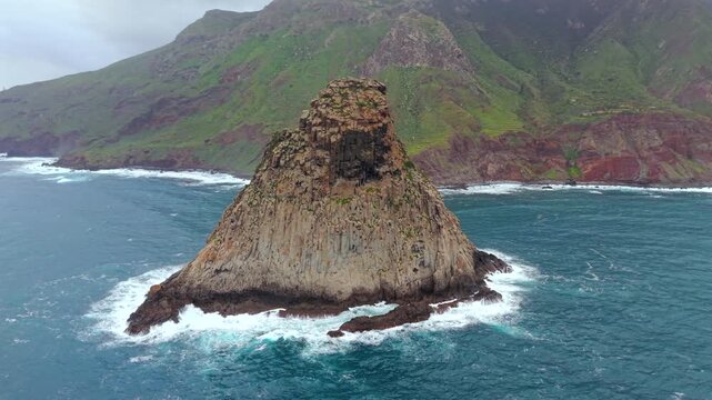 Stunning aerial perspective of the iconic Roques de Anaga near Benijo beach. Turquoise ocean waves crashing against the volcanic sea stacks. Tenerife.