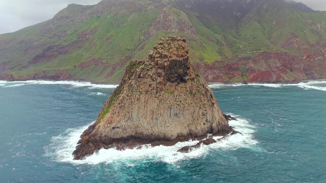 Dramatic aerial view of the iconic Roques de Anaga volcanic formations on Benijo beach, with ocean waves crashing against the rocks. Tenerife.