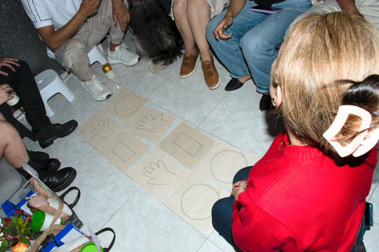Group of People Playing a Game on a Tiled Floor in a Room