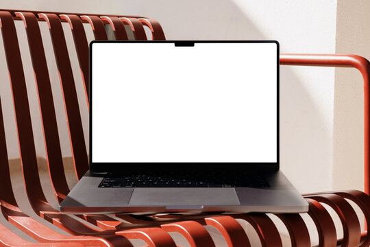 Laptop mockup with white screen on red chair summer