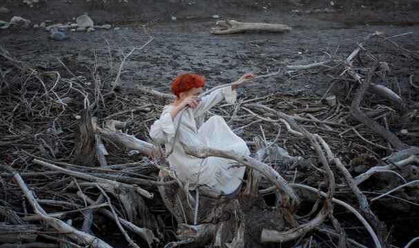 A woman among the dry branches 
