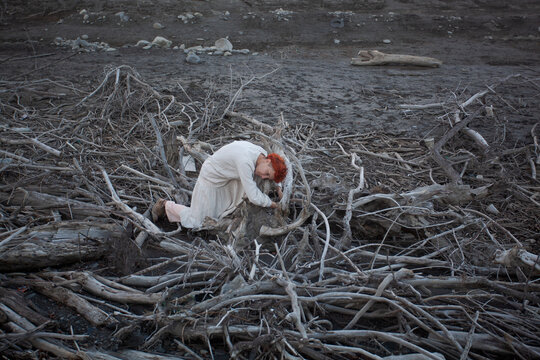 A woman among the dry branches 