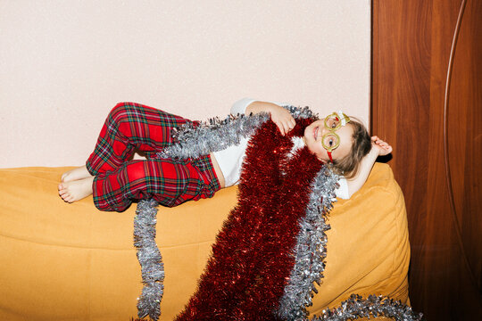 The child is resting on the Sofa.