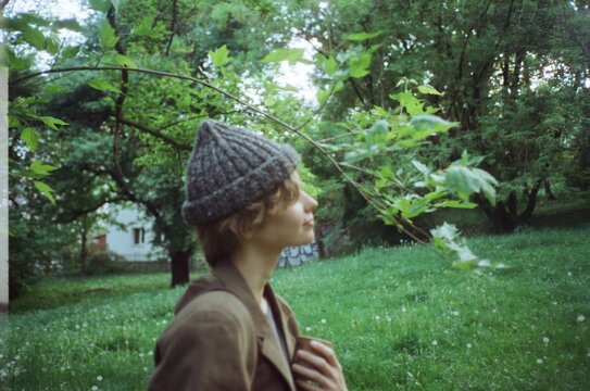 portrait of a young woman playing on a hayfield