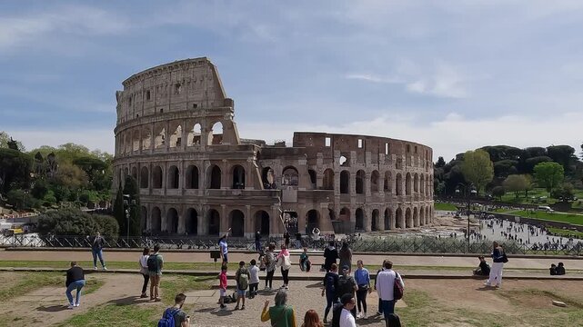 RomAerial drone shot over tourist people visiting the Flavian Amphitheatre, aka Colosseum in Rome, Italy