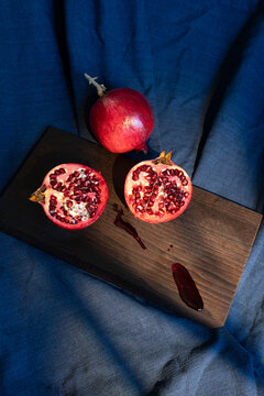 Cut Pomegranate Still Life on Blue Fabric