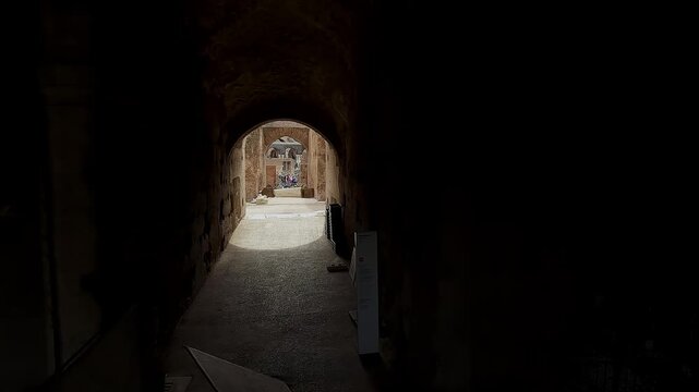 Tourist pov cinematic shot of Colosseum interior passage in Rome, Italy