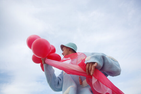A woman with the pink ballons 