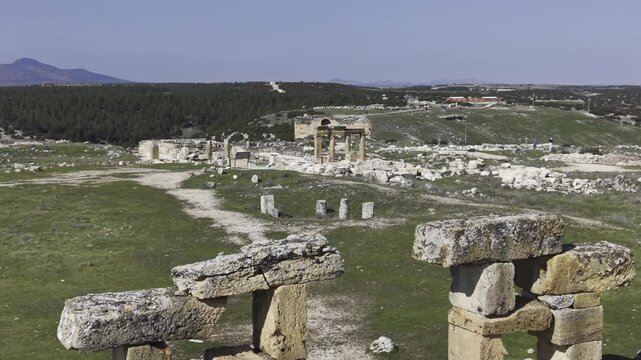 Cinematic aerial drone video footage of Blaundus Ancient City near Ulubey in Usak, Turkey, featuring ancient ruins, stone structures, and dramatic landscape from above in the Aegean region.
