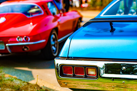 Classic 1960s American Muscle Car Detail: Vintage Blue Paint and Chrome Rear Bumper with Iconic Taillights