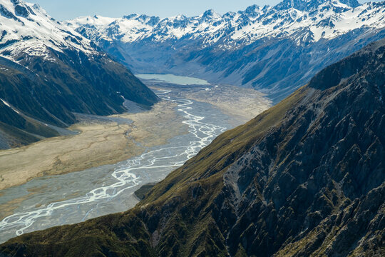 Valley with braided river leading to a glacial lake in NZ.
