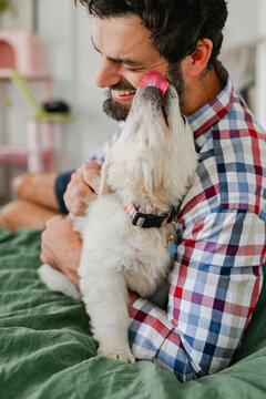Man licked by puppy