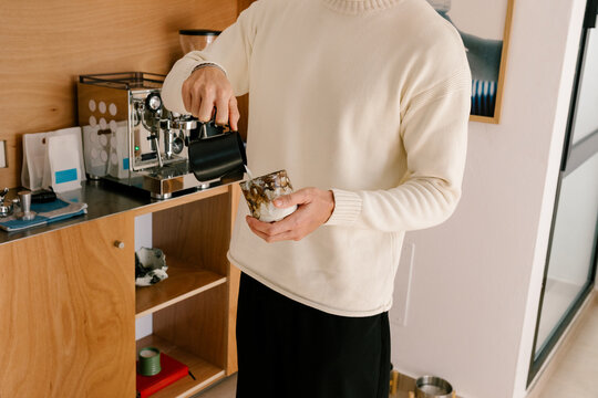 Unknown single man making coffee on a quiet morning