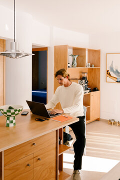 Full body shot of a contemporary man working from home