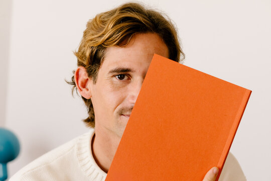 Conceptual close-up portrait of a young mustached man