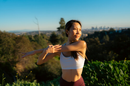 Woman stretches in sun
