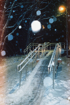Snowy Ramp at Night with Falling Snowflakes  
