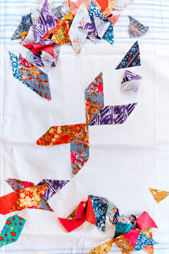Colorful Fabric Pieces Create an Artistic Arrangement on White Fabric