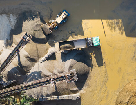 Aerial View of Gravel Processing Plant with Trucks and Conveyors