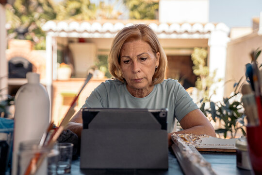 Portrait of a beautiful senior woman using her digital tablet