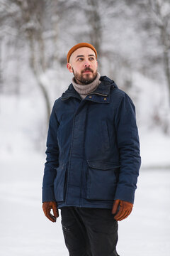 Portrait of a man standing in a winter snowy landscape