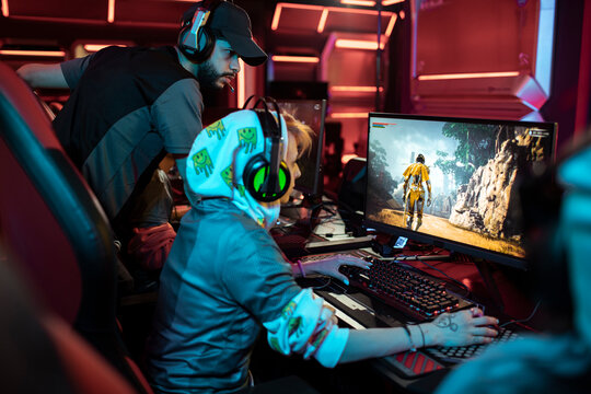 Coach guiding gamer at esports arena