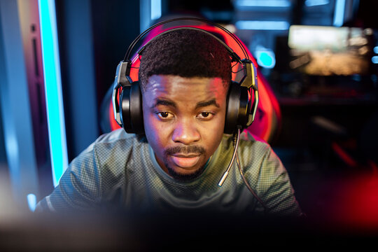 Young man wearing gaming headset in gaming room