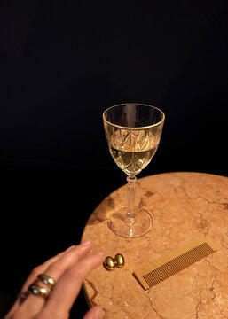 Glass of Drink on Table With Comb and Small Objects Nearby