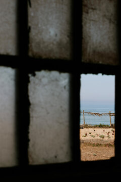 View of the ocean through a rustic window