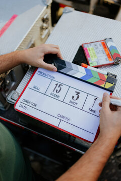 Filmmaker holding a clapperboard on set
