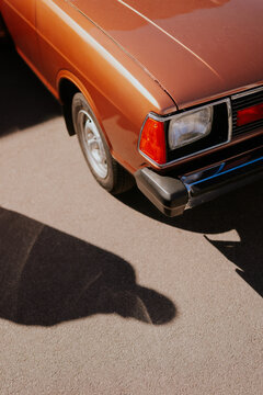 Vintage car front detail with shadow on pavement