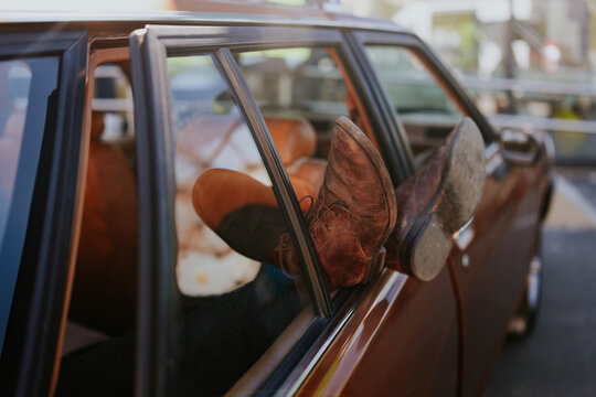 Relaxing in a classic car with feet out of the window