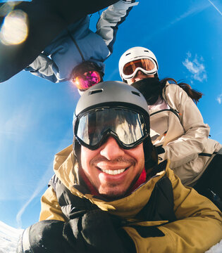 Group Taking Selfie While Skiing on Sunny Winter Day