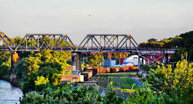 Scenic sunny view of a freight train and the historic steel truss Union Pacific Missouri River Bridge spanning the water at the Omaha riverfront.