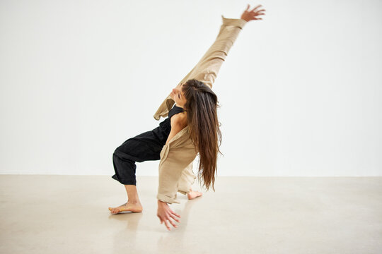 Dance performance in a studio with a plain background
