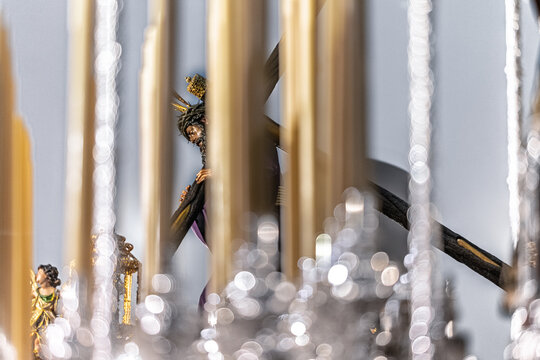 Christ of Gran Poder viewed through candles, canopy poles of palio float