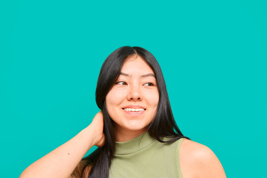 Confident woman smiling with hand behind neck