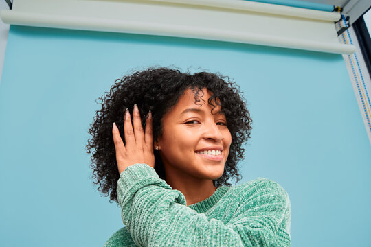 Young woman showing off healthy natural curls with confidence