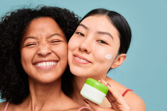 Smiling friends promoting skincare cream
