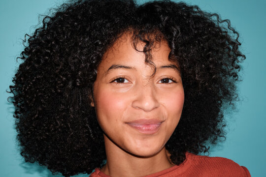 Close-up portrait of a woman with natural skin and curly hair