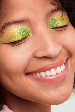 Close-up of colorful glitter eyeshadow on closed eyelids 