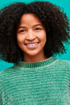 Portrait of young woman with curly hair and healthy skin