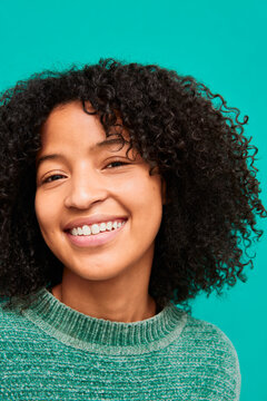 Close-up of young woman with curly hair and glowing natural skin