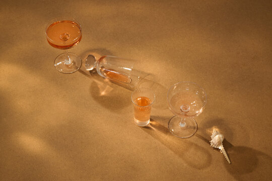 Elegant arrangement of cocktail glasses and a seashell