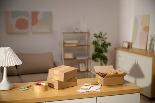 Cardboard boxes and packing supplies on a wooden table