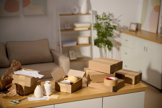 Cardboard boxes ready for shipping on a table in a cozy living