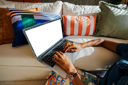 Woman typing on laptop working remotely from home