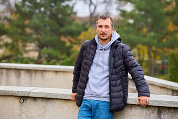 Man stands outdoors, leaning on a stone barrier © Iurii Gagarin